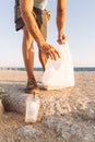 Man picking up plastic at the beach