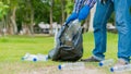 Man picking up plastic bottles, picking up trash in the world, cleaning the forest in the park. to preserve the charity environmen