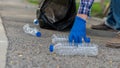 Man picking up plastic bottles, picking up trash in the world, cleaning the forest in the park. to preserve the charity environmen