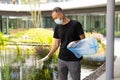 man picking up plastic household waste in park Royalty Free Stock Photo