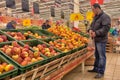 Man picks apples in the supermarket