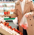 Man picks fresh tomatoes in the supermarket Royalty Free Stock Photo