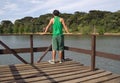 Man on pier by scenic lake