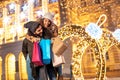 Man piggybacking woman while doing Christmas shopping