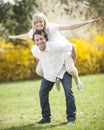 Man piggybacking woman in park Royalty Free Stock Photo