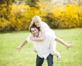 Man piggybacking woman in park Royalty Free Stock Photo