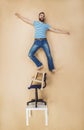 Man on a pile of chairs Royalty Free Stock Photo