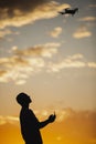 Man piloting a drone during the sunrise