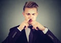 Man pinches nose with fingers looks with disgust something stinks bad smell. Royalty Free Stock Photo