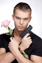 Man with pink rose and gun Royalty Free Stock Photo