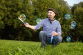 Man in pirate suit is blowing soap bubbles