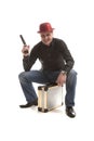 Man with a pistol sitting on the case Royalty Free Stock Photo