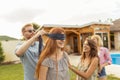Man placing blindfold over woman`s eyes while playing blind man`s buff