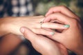 Man placing engagement ring on the finger of his fiance Royalty Free Stock Photo