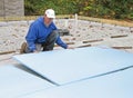 Man placing foam insulation Royalty Free Stock Photo