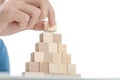 Man placing the last brick on top of the stack