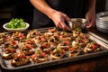 man placing mushroom bruschetta slices on a tray