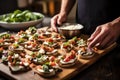 man placing mushroom bruschetta slices on a tray