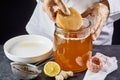 Man placing the scoby or fungus in black tea