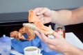 Man placing sliced ham on his roll Royalty Free Stock Photo