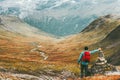 Man placing stone to rock cairn marking route