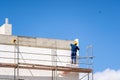 Man placing styrofoam material insulate concrete wall Royalty Free Stock Photo