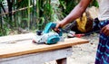 Man planed board Electrical plane. Construction, wood processing Royalty Free Stock Photo