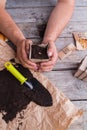 Man planted seed in a small paper fibre pot.