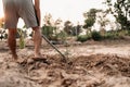 Man plants a small tamarind tree, hands holds shovel digs the ground garden. Farm and argiculture at countryside concept Royalty Free Stock Photo