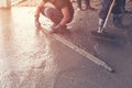 Man plasterer screed concrete on cement for floor in building c Royalty Free Stock Photo