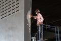 The man plastering sanding the plaste in drywall seam in factory Royalty Free Stock Photo