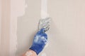 Man plastering wall with putty knife indoors, closeup. Home renovation Royalty Free Stock Photo