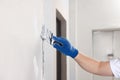 Man plastering wall with putty knife indoors, closeup. Home renovation Royalty Free Stock Photo