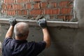 Man plastering wall. Worker makes renovation. Construction work Royalty Free Stock Photo