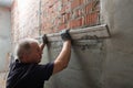 Man plastering wall. Worker makes renovation. Construction work Royalty Free Stock Photo