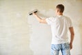 Man plastering the walls with finishing putty in the room Royalty Free Stock Photo