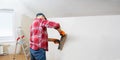 Man are plastering the walls of the house. DIY home renovation. Royalty Free Stock Photo