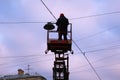 The man on the platform repairs the lantern Royalty Free Stock Photo