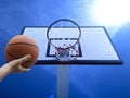 A man play basketball. Low angle view of basketball hoop against blue sky Royalty Free Stock Photo