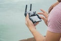 Close up man play mobile Drone by remote control joystick with smartphone Royalty Free Stock Photo