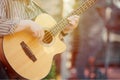 Man playing acoustic bass guitar at outdoor event, close up view to guitar neck Royalty Free Stock Photo