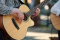 Man playing acoustic bass guitar at outdoor event, close up view to guitar neck Royalty Free Stock Photo