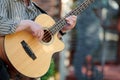 Man playing acoustic bass guitar at outdoor event, close up view to guitar neck Royalty Free Stock Photo