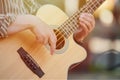 Man playing acoustic bass guitar at outdoor event, close up view to guitar neck Royalty Free Stock Photo