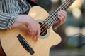 Man playing acoustic bass guitar at outdoor event, close up view to guitar neck Royalty Free Stock Photo