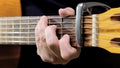 A man playing on acoustic guitar closeup and front view. A male musician plays the guitar Royalty Free Stock Photo