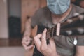 Man playing acoustic guitar in home quarantine self-isolation Royalty Free Stock Photo