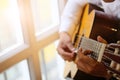 Man playing an acoustic guitar with vintage tone Royalty Free Stock Photo