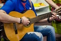 Man Playing Amplified Acoustic Guitar