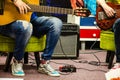 Man Playing Amplified Acoustic Guitar